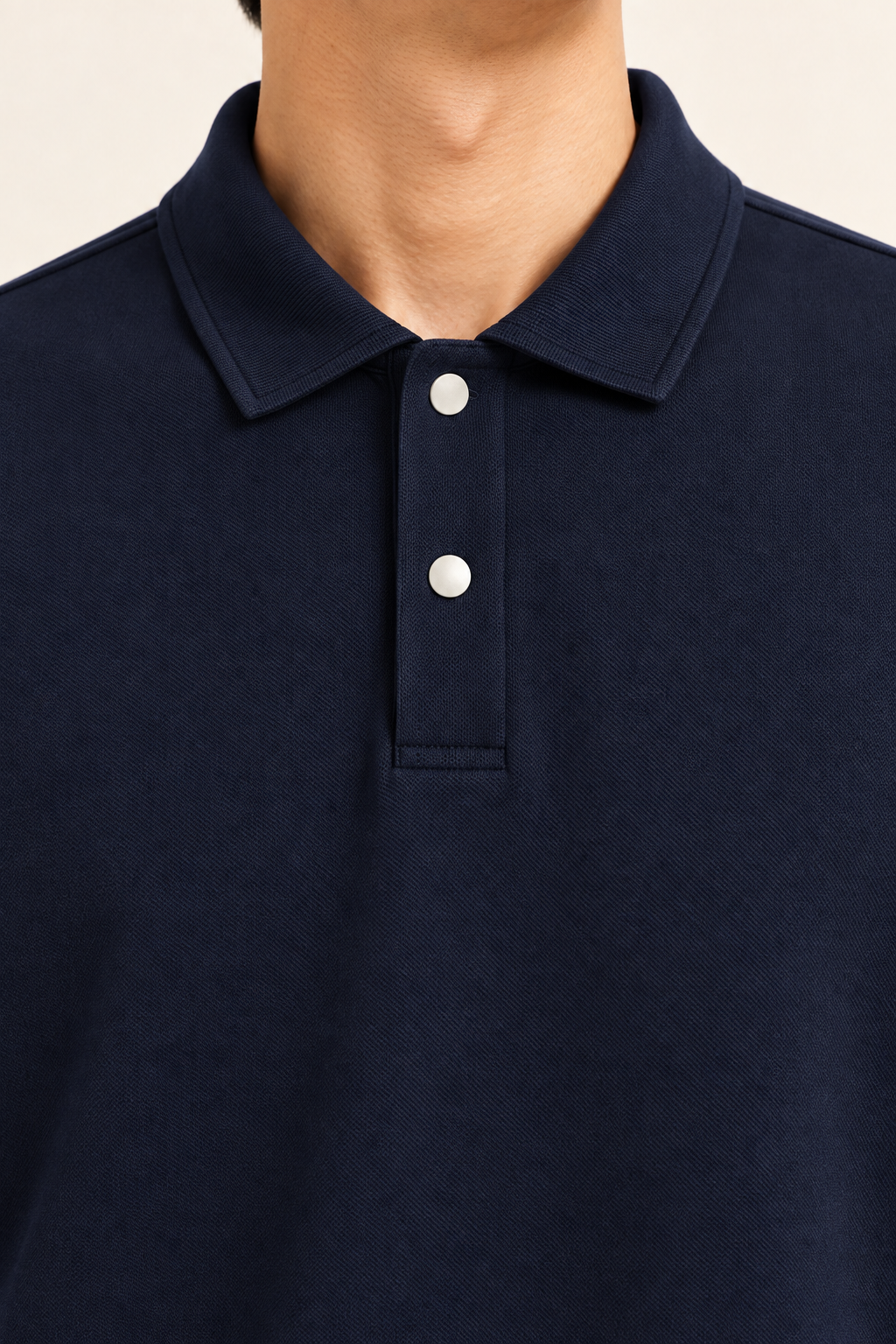 Quiet Club Polo Sweatshirt in Dark Blue. Close-up of the pointed collar, pale buttons and fabric texture.