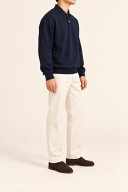 Quiet Club Polo Sweatshirt in Dark Blue. Three-quarter side view showing dropped shoulders and ribbed cuffs.