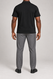 Clean Interval Zip Polo in Black. Rear view showing the upper back yoke seam and short sleeves.