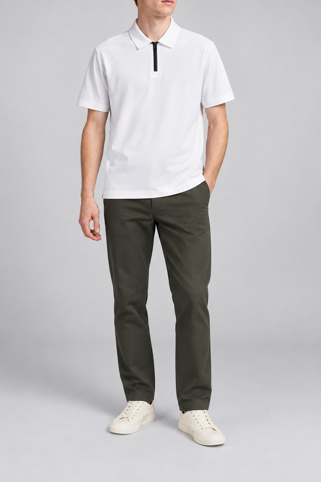 Clean Interval Zip Polo in White. Front view showing the plain white body and contrasting black quarter zip.