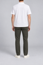 Clean Interval Zip Polo in White. Rear view showing the upper back yoke seam and short sleeves.