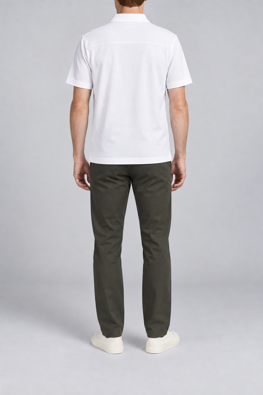 Clean Interval Zip Polo in White. Rear view showing the upper back yoke seam and short sleeves.
