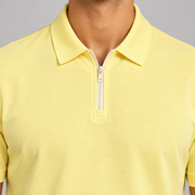Clean Interval Zip Polo in Light Yellow. Close-up of the pointed collar and pale ivory zipper.