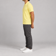 Clean Interval Zip Polo in Light Yellow. Side view showing the regular short sleeve and straight hem.