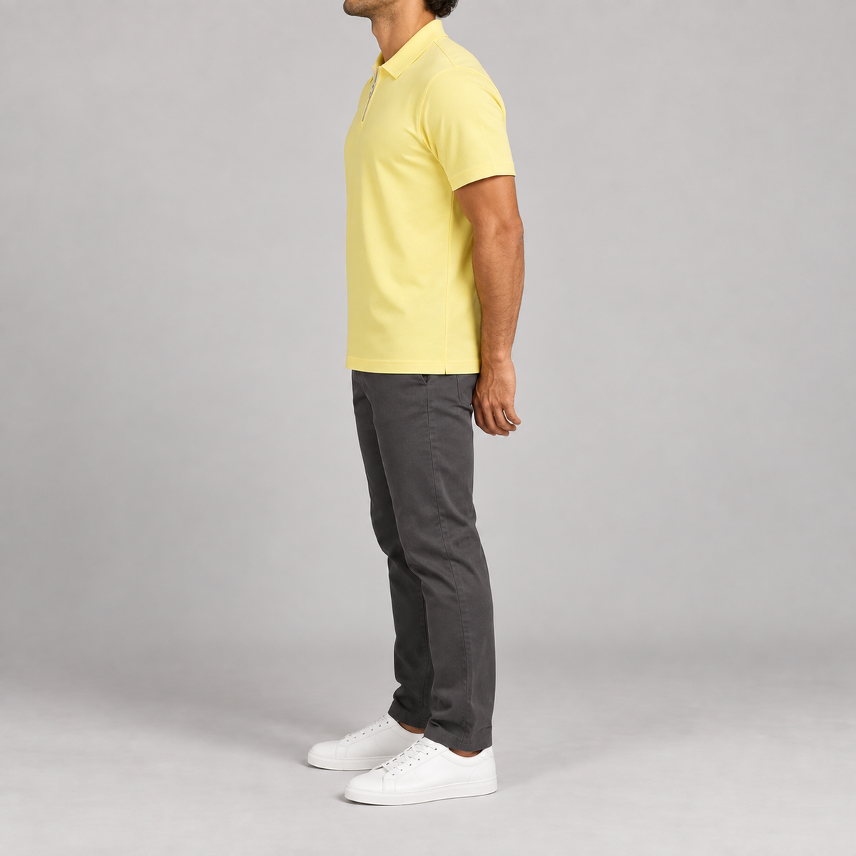 Clean Interval Zip Polo in Light Yellow. Side view showing the regular short sleeve and straight hem.