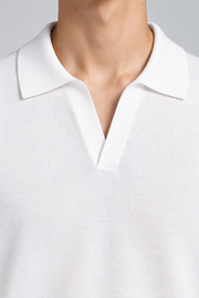 Still Hour Knit Polo in White. Close-up of the ribbed collar and buttonless V neckline.