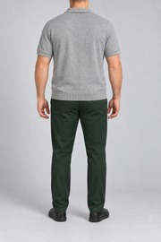 Rear studio view showing the plain back and ribbed hem of Still Hour Knit Polo in Flower Gray.