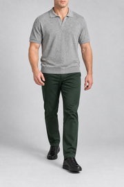 Walking studio view showing the relaxed drape and short sleeves of Still Hour Knit Polo in Flower Gray.