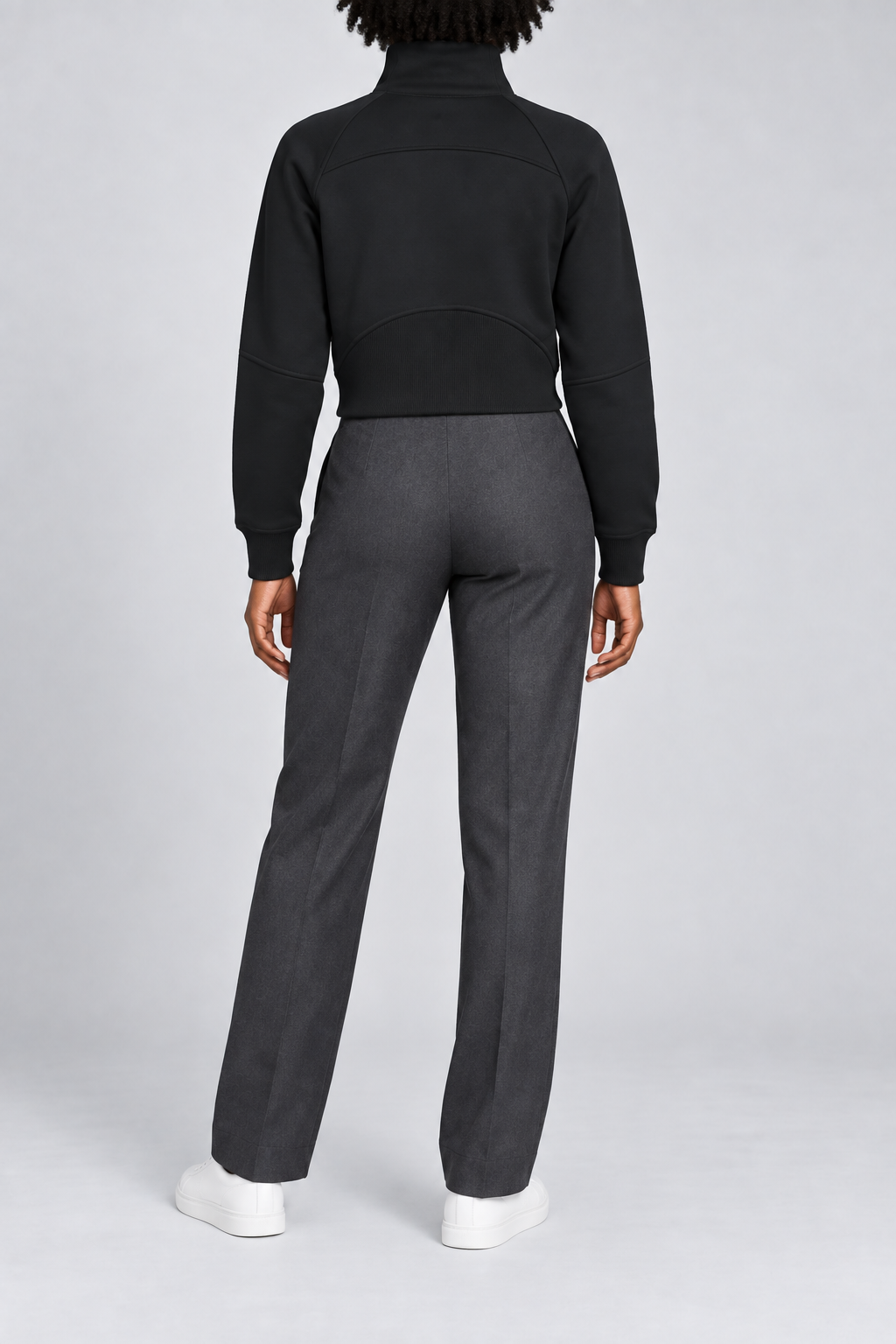 Rear studio view showing the curved yoke and ribbed back hem panel of Curve Interval Half-Zip Sweatshirt in Black.
