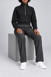 Seated studio view showing the cropped shape and ribbed cuffs of Curve Interval Half-Zip Sweatshirt in Black.