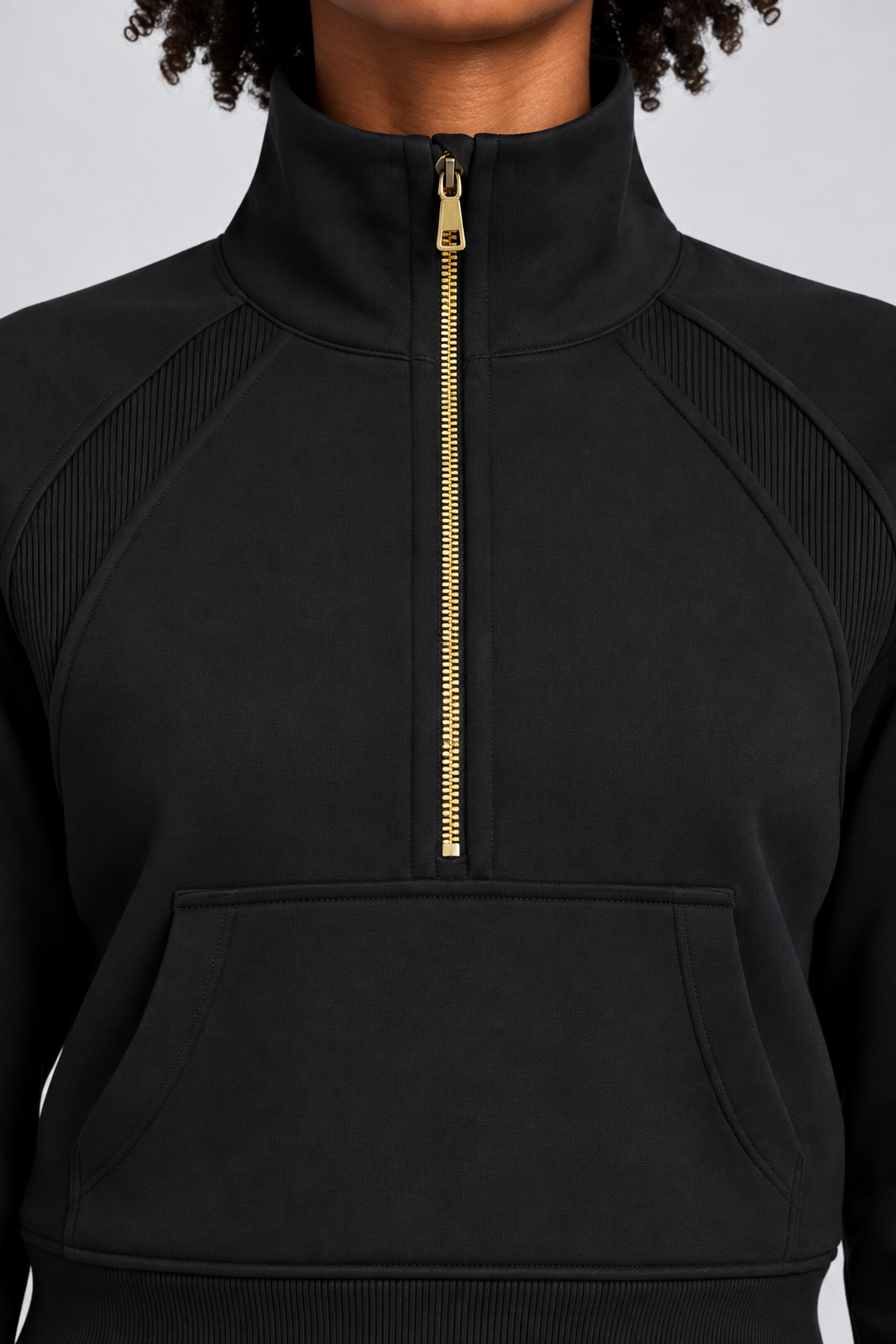 Close-up studio view showing the high collar, gold-tone zip and ribbed shoulder inserts of Curve Interval Half-Zip Sweatshirt in Black.