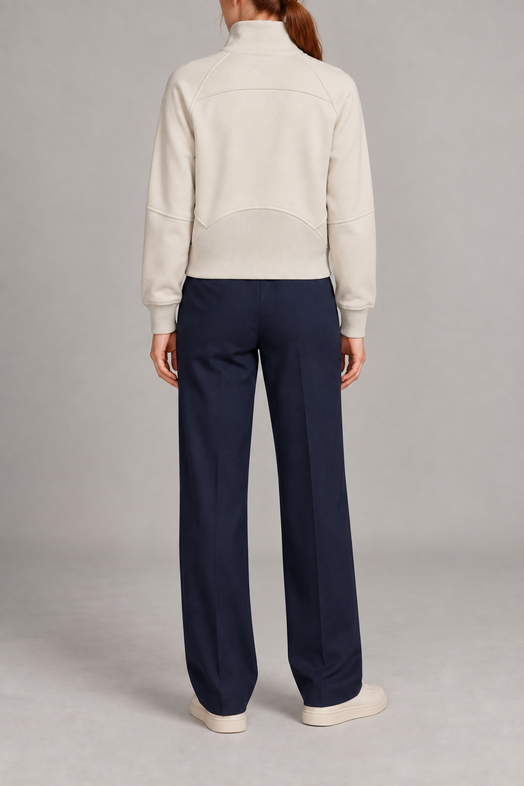 Rear studio view showing the curved yoke and ribbed back hem panel of Curve Interval Half-Zip Sweatshirt in White.