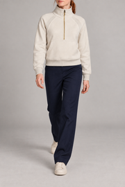 Walking studio view showing the cropped shape and long raglan sleeves of Curve Interval Half-Zip Sweatshirt in White.