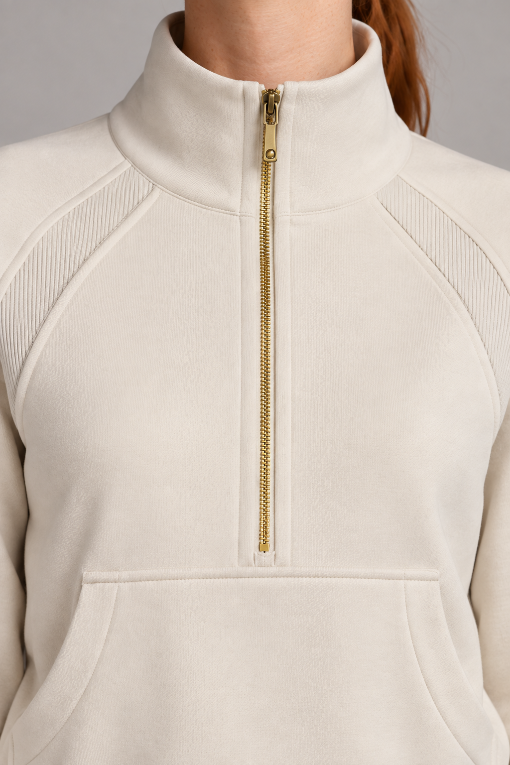 Close-up studio view showing the high collar, gold-tone zip and ribbed shoulder inserts of Curve Interval Half-Zip Sweatshirt in White.