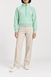 Front studio view showing the silver-tone half zip and kangaroo pocket of Curve Interval Half-Zip Sweatshirt in Green.
