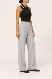 Three-quarter side studio view showing the ribbed texture and bound armholes of Court Line Polo Tank in Black with White.