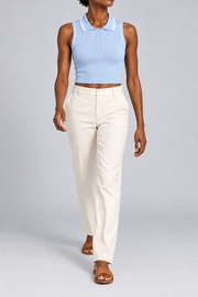 Walking studio view showing the close cropped fit and sleeveless shape of Court Line Polo Tank in Blue with White.