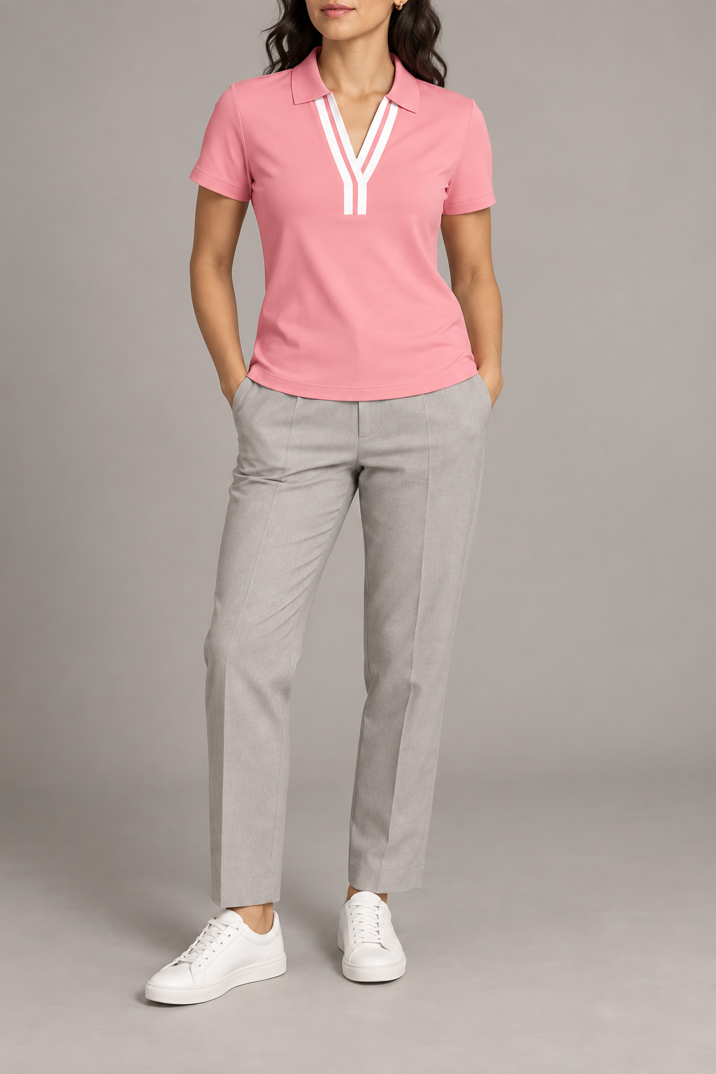 Court Ease V-Neck Polo in Pink. Front studio view showing the white-banded V neckline and slim silhouette.