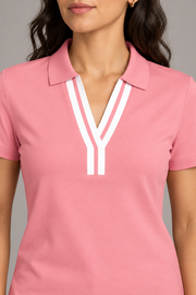 Court Ease V-Neck Polo in Pink. Close-up showing the pink ribbed collar and white neckline bands.
