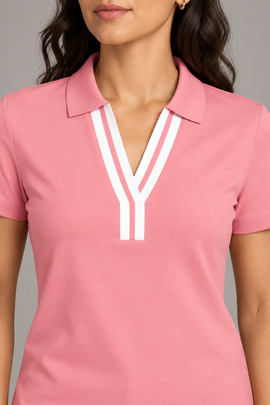 Court Ease V-Neck Polo in Pink. Close-up showing the pink ribbed collar and white neckline bands.