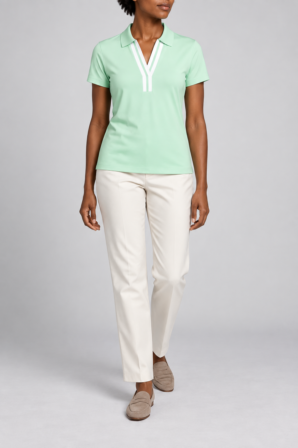 Court Ease V-Neck Polo in Mint Green. Front studio view showing the white-banded neckline and slim mint silhouette.