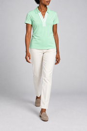 Court Ease V-Neck Polo in Mint Green. Walking studio view showing the mint green polo's natural drape.