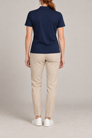 Court Ease V-Neck Polo in Navy Blue. Rear studio view showing the plain navy blue back and short sleeves.