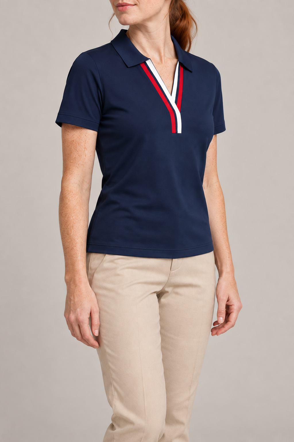Court Ease V-Neck Polo in Navy Blue. Three-quarter studio view showing short sleeves and a straight hem.