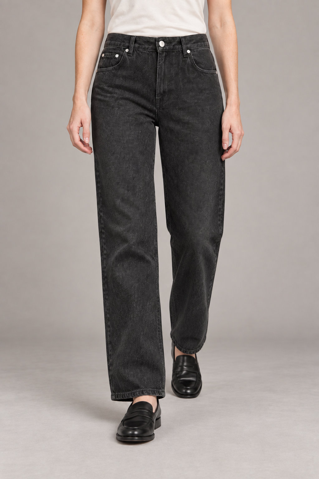 Worn Rhythm Straight Jeans in Black. Walking studio view showing the black jeans' straight-leg drape.