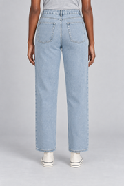 Worn Rhythm Straight Jeans in Blue. Rear studio view showing two plain patch pockets and neat topstitching.