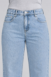 Worn Rhythm Straight Jeans in Blue. Close-up showing the blue denim waistband, coin pocket and silver-tone rivets.