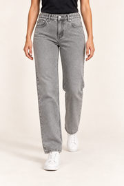 Worn Rhythm Straight Jeans in Light Gray. Walking studio view showing the light gray jeans' straight-leg drape.