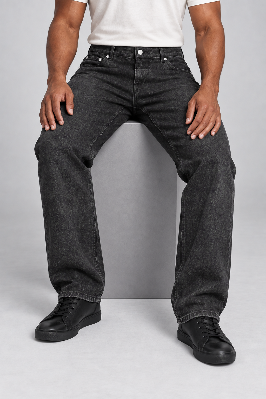 Walking studio view of Still Rhythm Straight Jeans in Black, showing the loose denim drape.