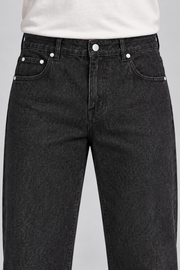 Close-up of Still Rhythm Straight Jeans in Black, showing the button, belt loops, coin pocket and rivets.