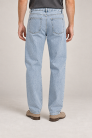 Rear studio view of Still Rhythm Straight Jeans in Blue, showing plain patch pockets and the back yoke.