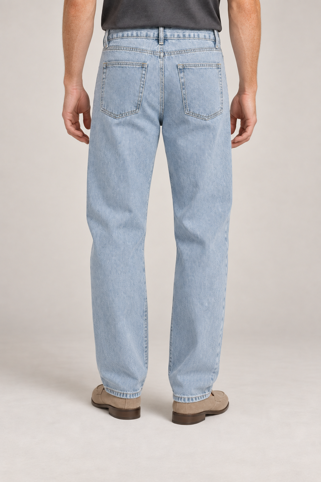 Rear studio view of Still Rhythm Straight Jeans in Blue, showing plain patch pockets and the back yoke.