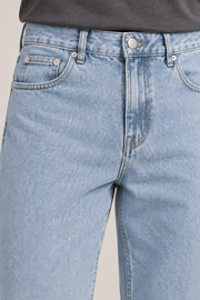 Close-up of Still Rhythm Straight Jeans in Blue, showing the button, belt loops, coin pocket and rivets.