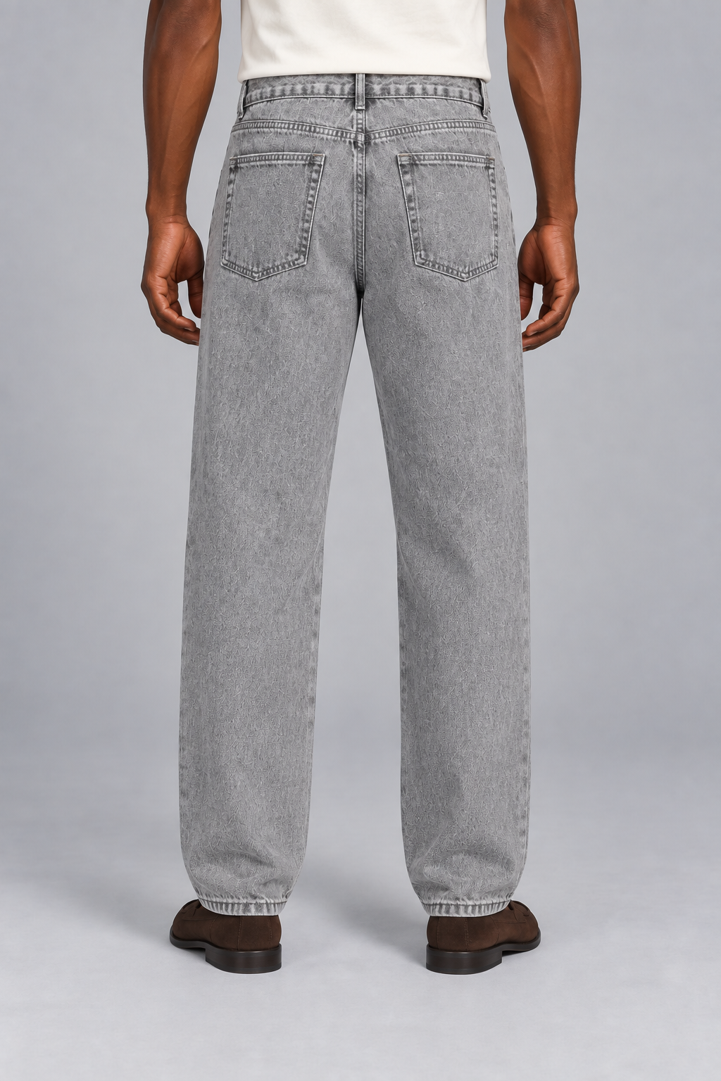 Rear studio view of Still Rhythm Straight Jeans in Light Gray, showing plain patch pockets and the back yoke.