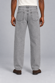 Rear studio view of Still Rhythm Straight Jeans in Light Gray, showing plain patch pockets and the back yoke.