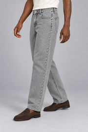 Three-quarter side studio view of Still Rhythm Straight Jeans in Light Gray, showing the loose straight silhouette.