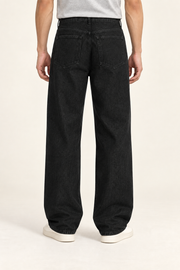 Rear studio view of Deep Interval Wide Leg Jeans in Black, showing plain patch pockets and tonal stitching.