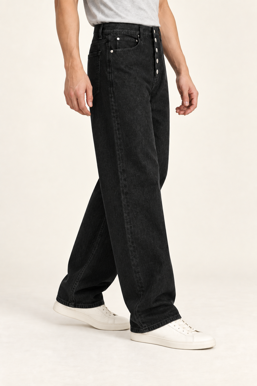 Side studio view of Deep Interval Wide Leg Jeans in Black, showing the full-length drape and button front.