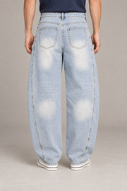 Rear studio view of Pale Orbit Barrel Jeans in Light Blue, showing faded patch pockets and the barrel silhouette.