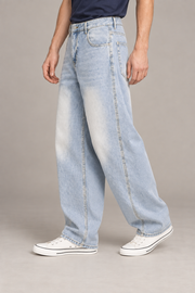 Three-quarter side studio view of Pale Orbit Barrel Jeans in Light Blue, showing curved seams and the pale vintage wash.