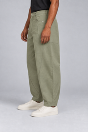 Side studio view of Field Arc Barrel Pants in Gray Green, showing the wraparound patch pocket and curved leg.