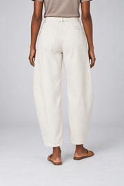 Rear studio view of Soft Arc Belted Chinos in White, showing two plain patch pockets and a loose silhouette.