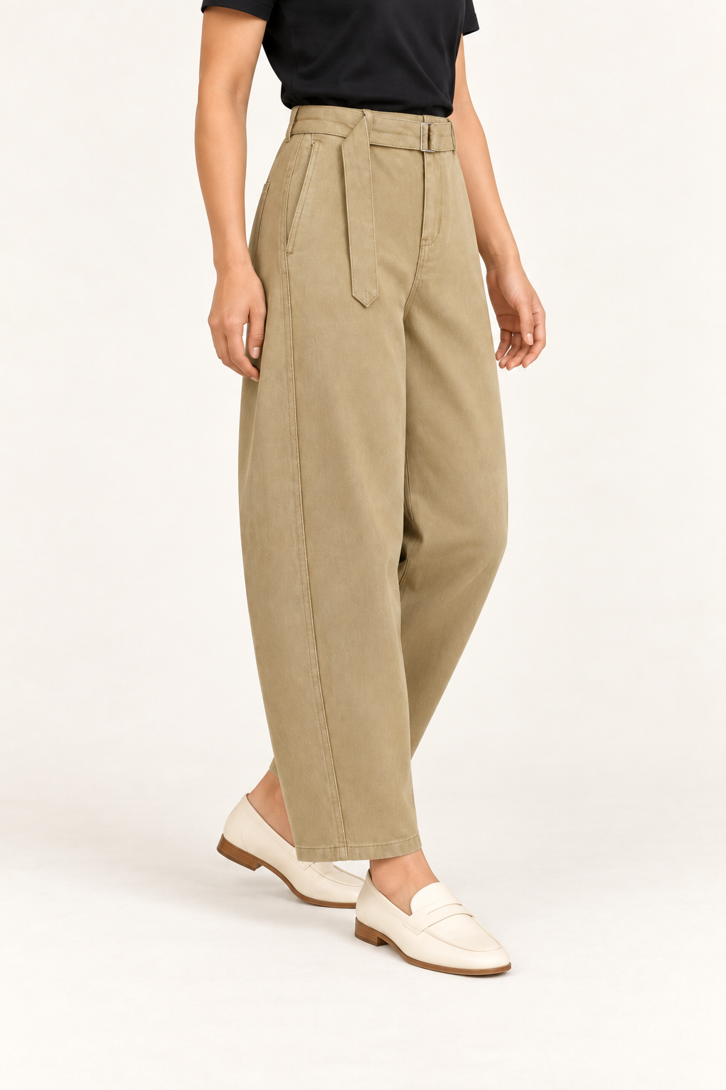 Three-quarter side studio view of Soft Arc Belted Chinos in Khaki, showing twisted seams and the metal belt buckle.