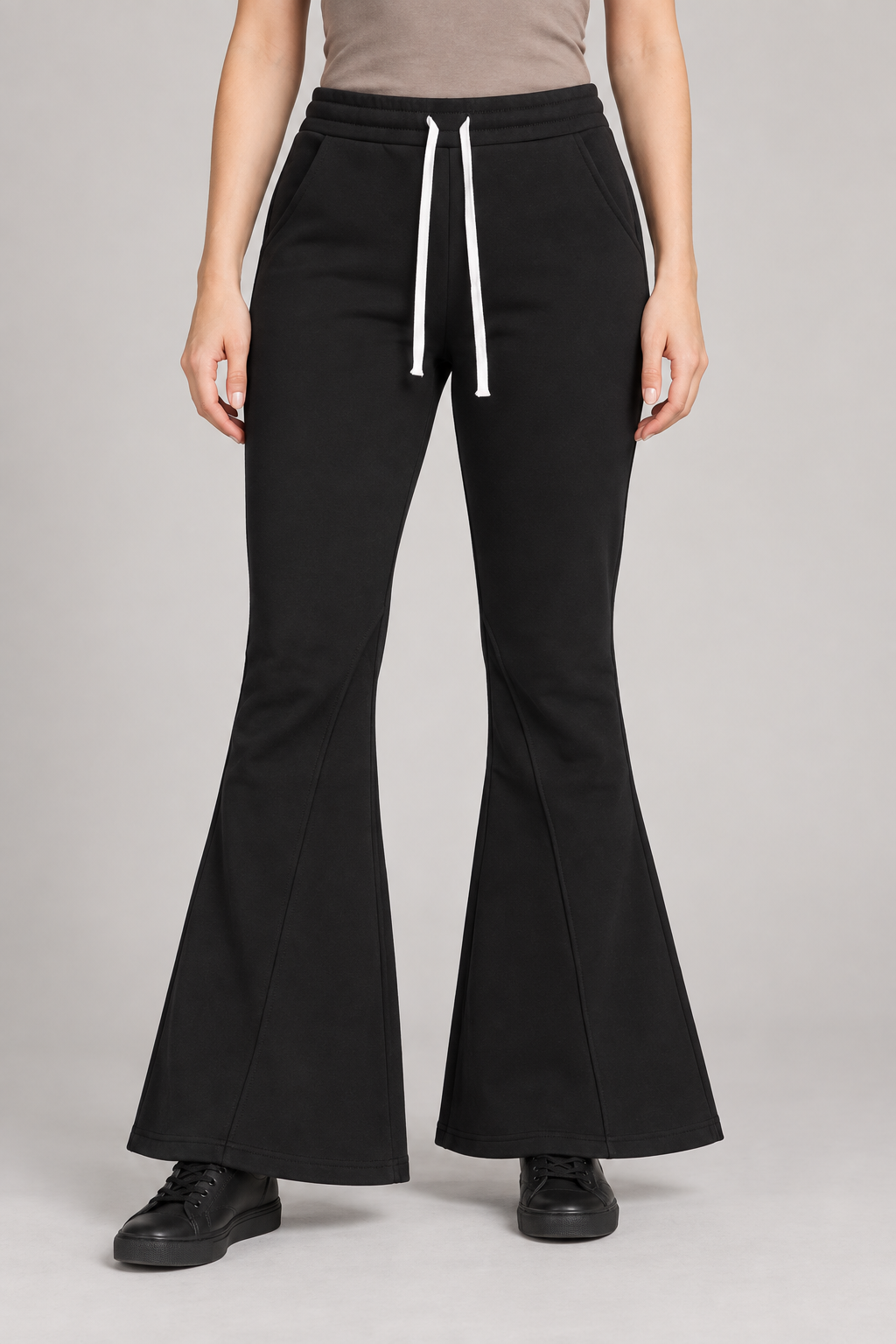 Front view of Quiet Bell Flared Sweatpants in Black, showing the white drawstring and shaped flared legs.