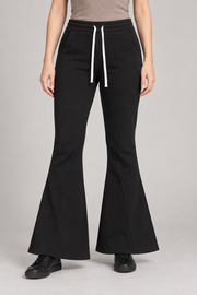 Front view of Quiet Bell Flared Sweatpants in Black, showing the white drawstring and shaped flared legs.