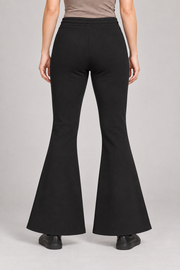 Rear view of Quiet Bell Flared Sweatpants in Black, showing the plain back and clean flared hems.
